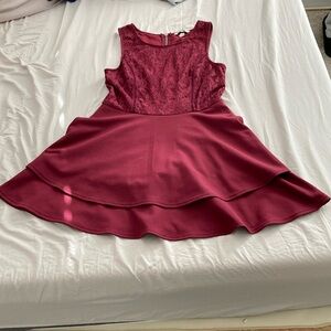 Maroon dress with pretty details on the top zipper in the back, no sleeves.